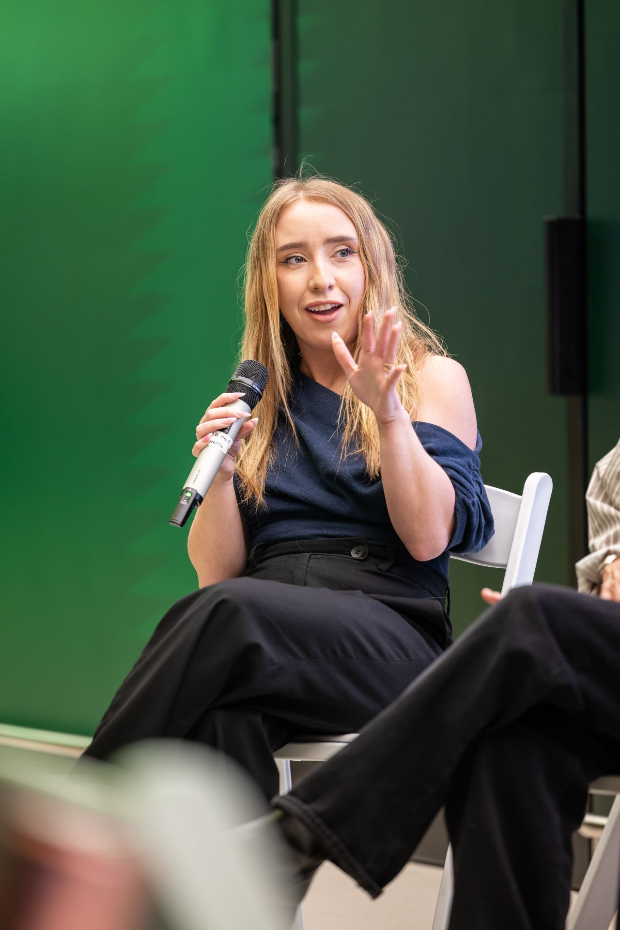Jade speaking into a microphone at Wise